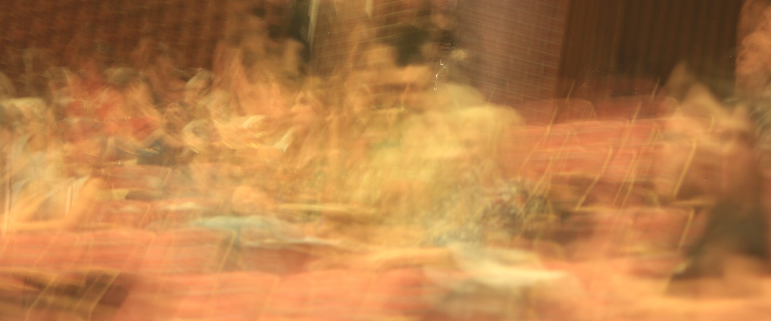 A long exposure photograph of the inside of the event venue; it looks dynamic and flowing,.
